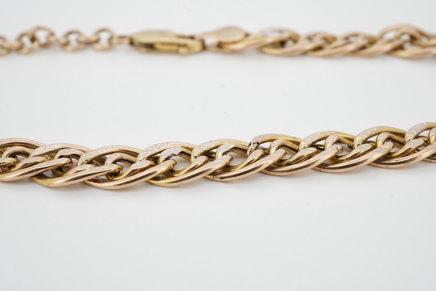 A 9ct gold double curb link bracelet, with white gold details, length 23cm, British hallmarks, gross weight 7 grams, Condition: good